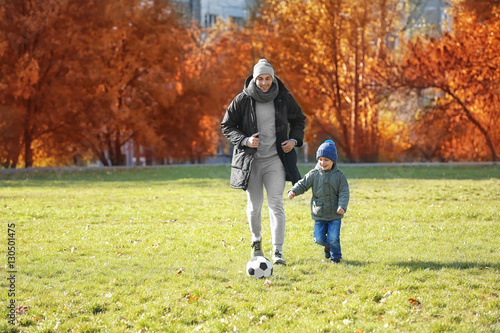 Father and son playing foot...
