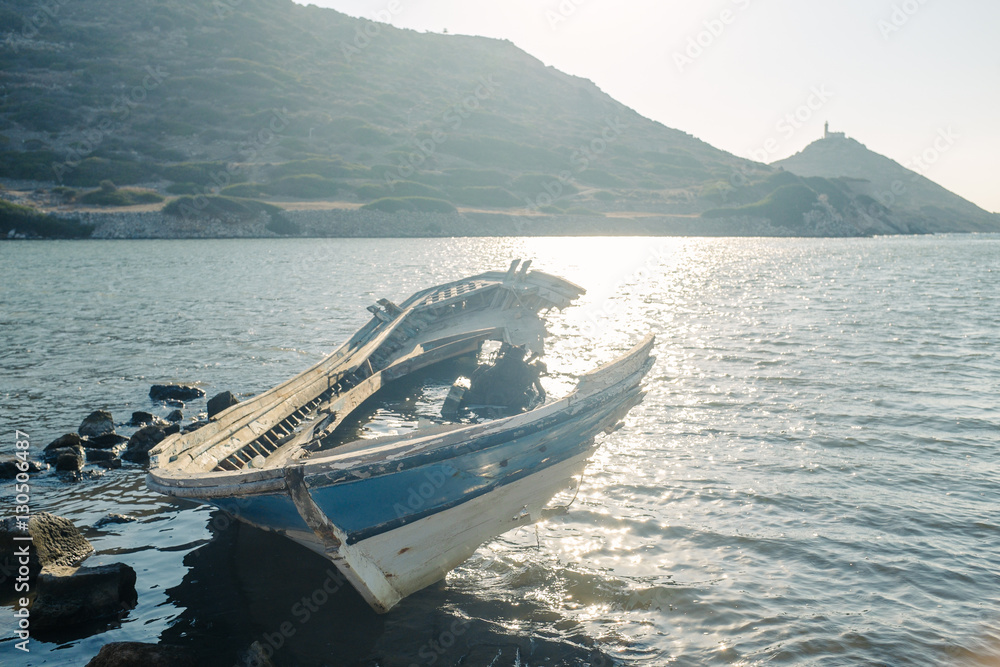 An old broken boat on the seaboard