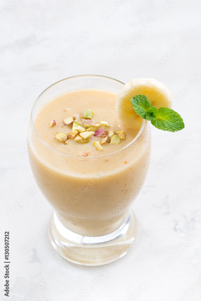 banana smoothie in a glass, top view banana smoothie in a glass, top view