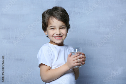 Cute little boy drinking wa...