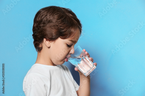 Cute little boy drinking wa...