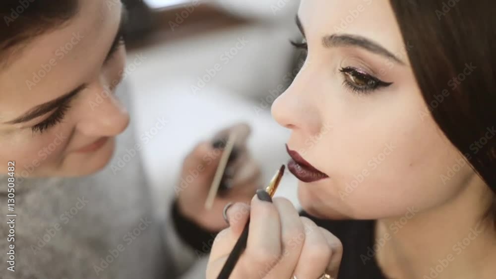 professional makeup artist paints a model lips,makeup, professional makeup, slow motion professional makeup artist paints a model lips,makeup, professional makeup, slow motion