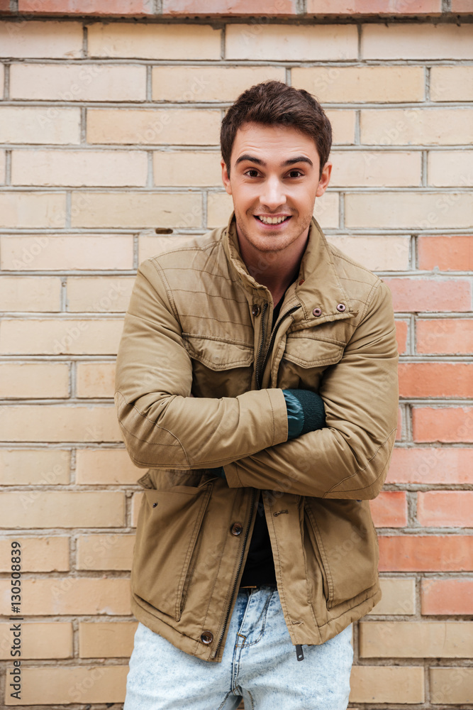 Cheerful young man walking on the street Cheerful young man walking on the street