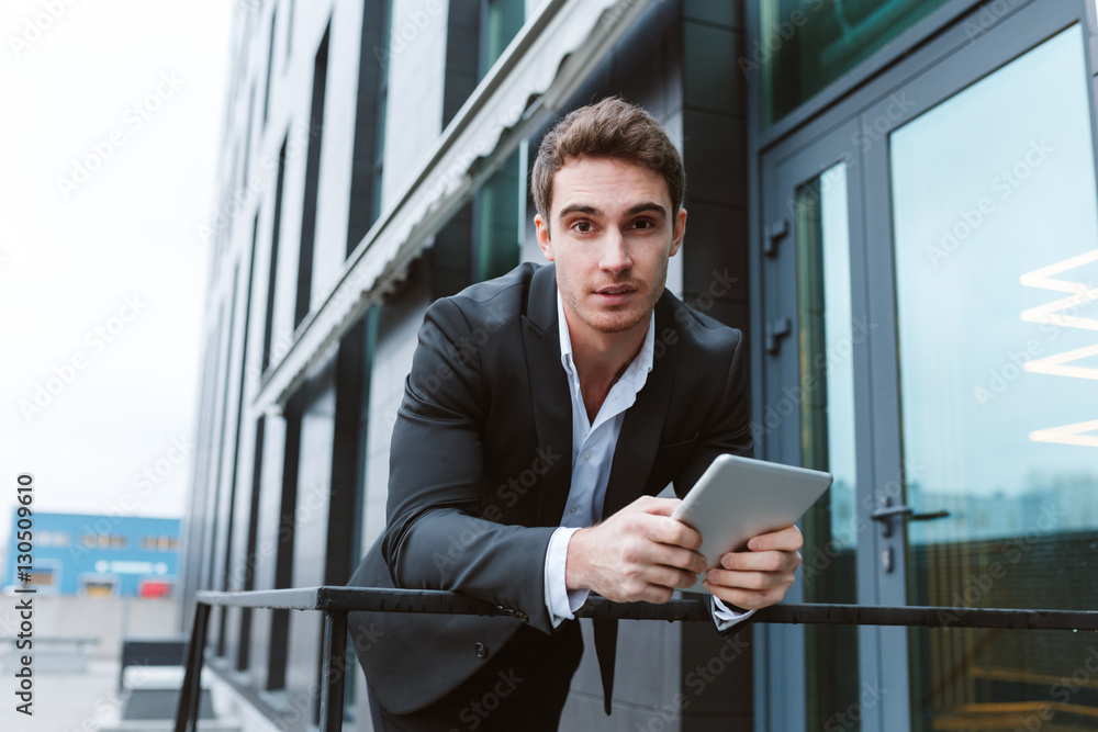 Fototapeta premium Business man standing with laptop computer