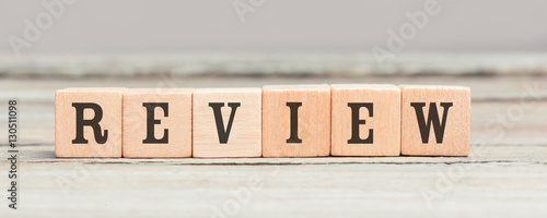 Word review written with wood cubes on table photo