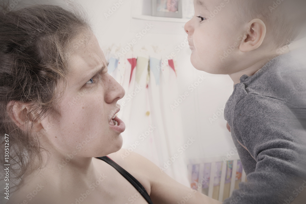 Mother suffering from postpartum depression shakes and screams at her baby Mother suffering from postpartum depression shakes and screams at her baby
