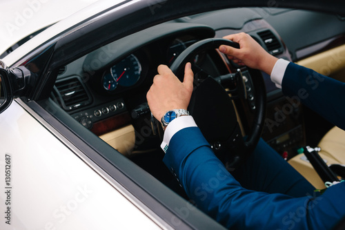 Successful businessman driving his car, hands on steering wheel close up © dron285