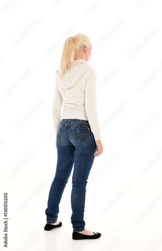 Full length portrait of a pretty girl wearing a casual white hoody and blue jeans. standing pose isolated against a white background. Full length portrait of a pretty girl wearing a casual white hoody and blue jeans. standing pose isolated against a white background.