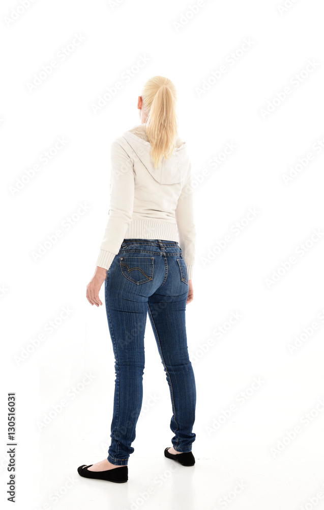 Full length portrait of a pretty girl wearing a casual white hoody and blue jeans. standing pose isolated against a white background. Full length portrait of a pretty girl wearing a casual white hoody and blue jeans. standing pose isolated against a white background.