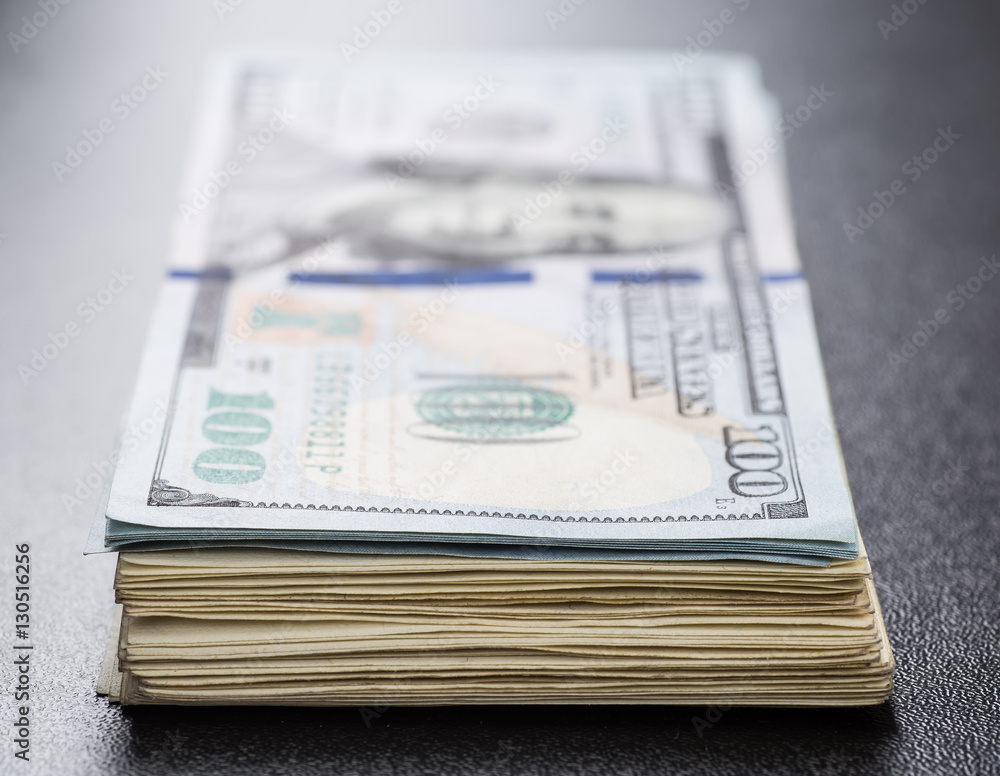 Money roll with US dollars. Selective focus. Money roll with US dollars. Selective focus.