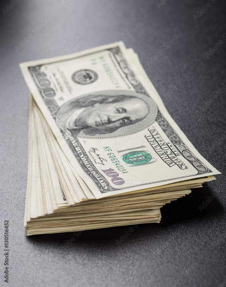 Money roll with US dollars. Selective focus. Money roll with US dollars. Selective focus.