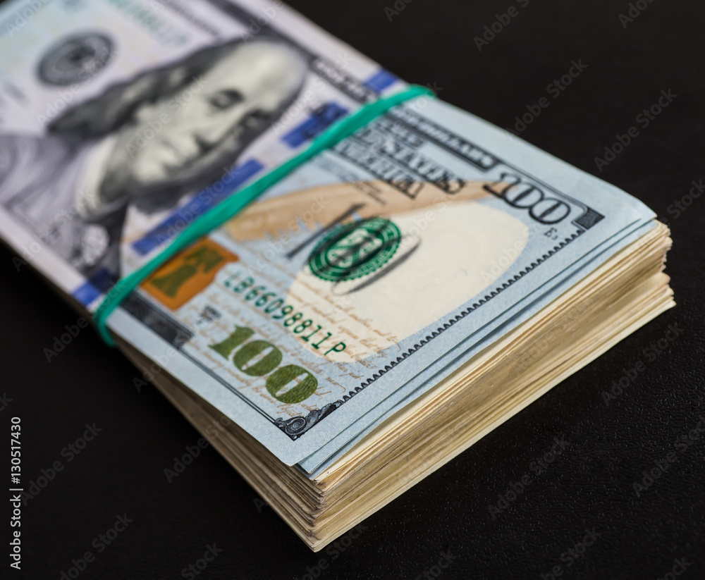 Money roll with US dollars. Selective focus. Money roll with US dollars. Selective focus.