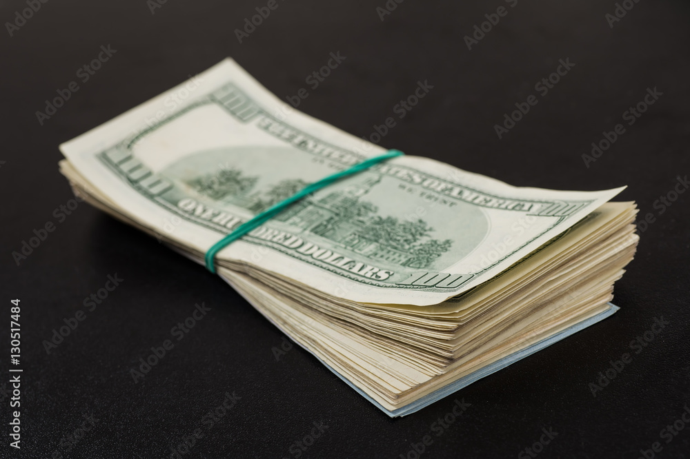 Money roll with US dollars. Selective focus. Money roll with US dollars. Selective focus.