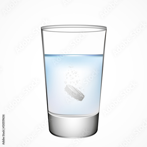 Effervescent tablet  in a glass of water, isolated on white