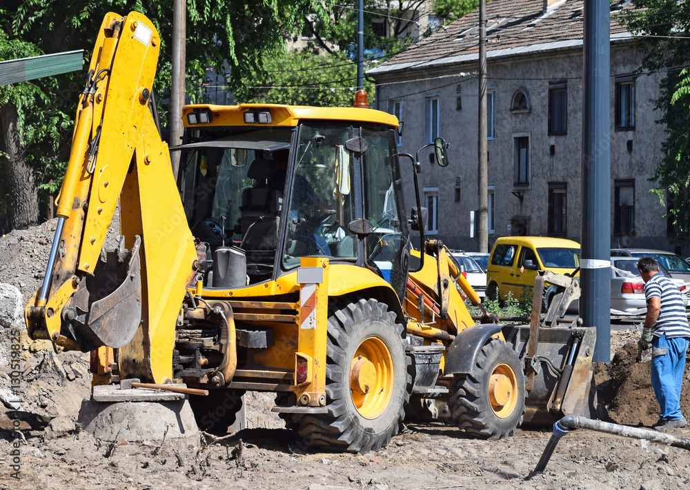 Excavator works at the road construction Excavator works at the road construction