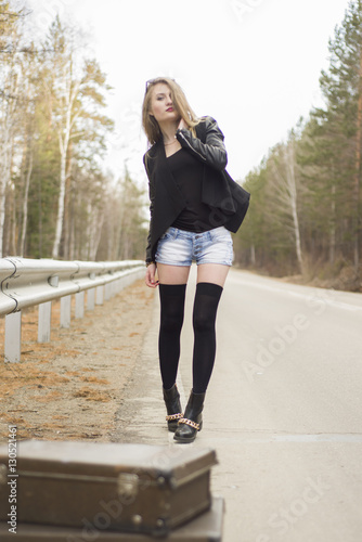 Beautiful young girl hitchhiking