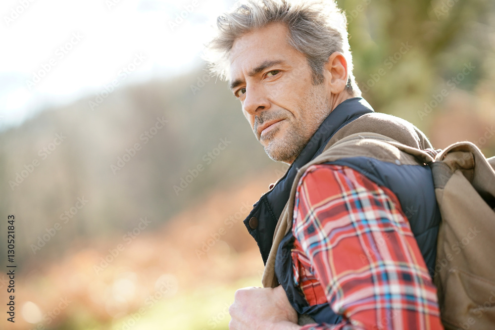 Hiker with backpack walking in the mountain Hiker with backpack walking in the mountain