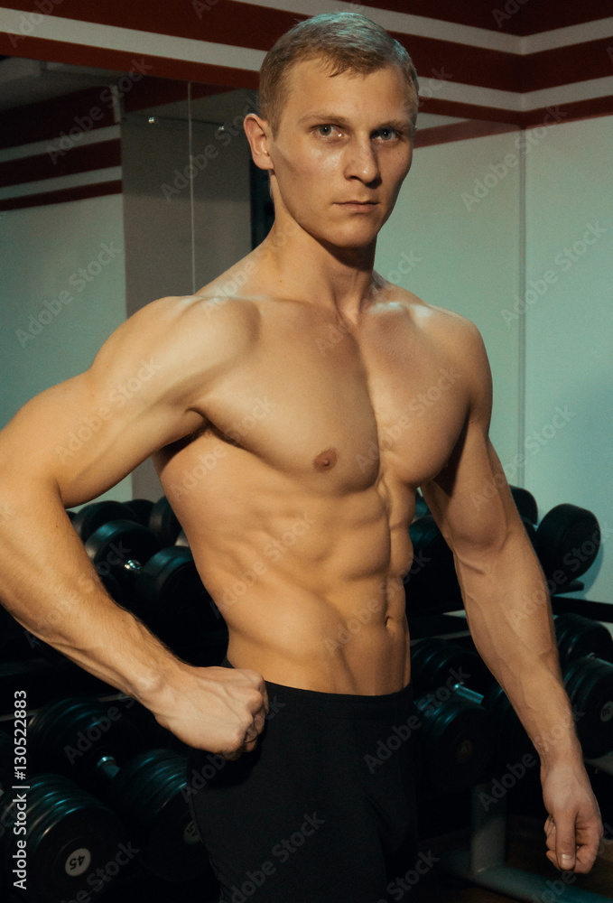 Beautiful bodybuilder posing in the gym. Beautiful bodybuilder posing in the gym.