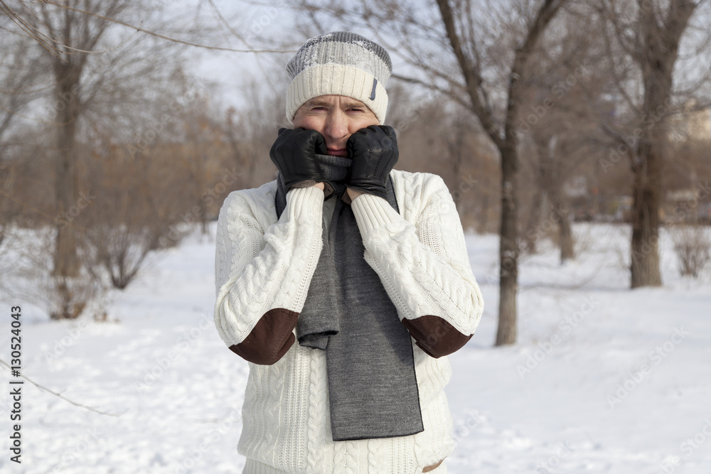The guy's portrait in white a sweater in the winter The guy's portrait in white a sweater in the winter