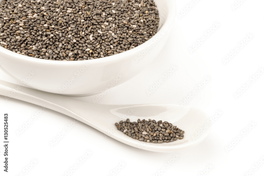 Organic dry chia seeds isolated over a white background Organic dry chia seeds isolated over a white background