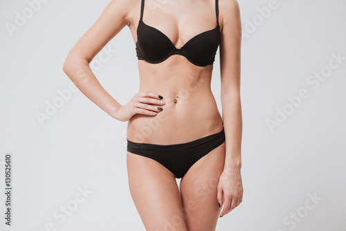 Cropped image of a beautiful slim woman body in lingerie