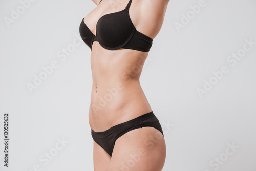Close up portrait of a female body wearing black lingerie