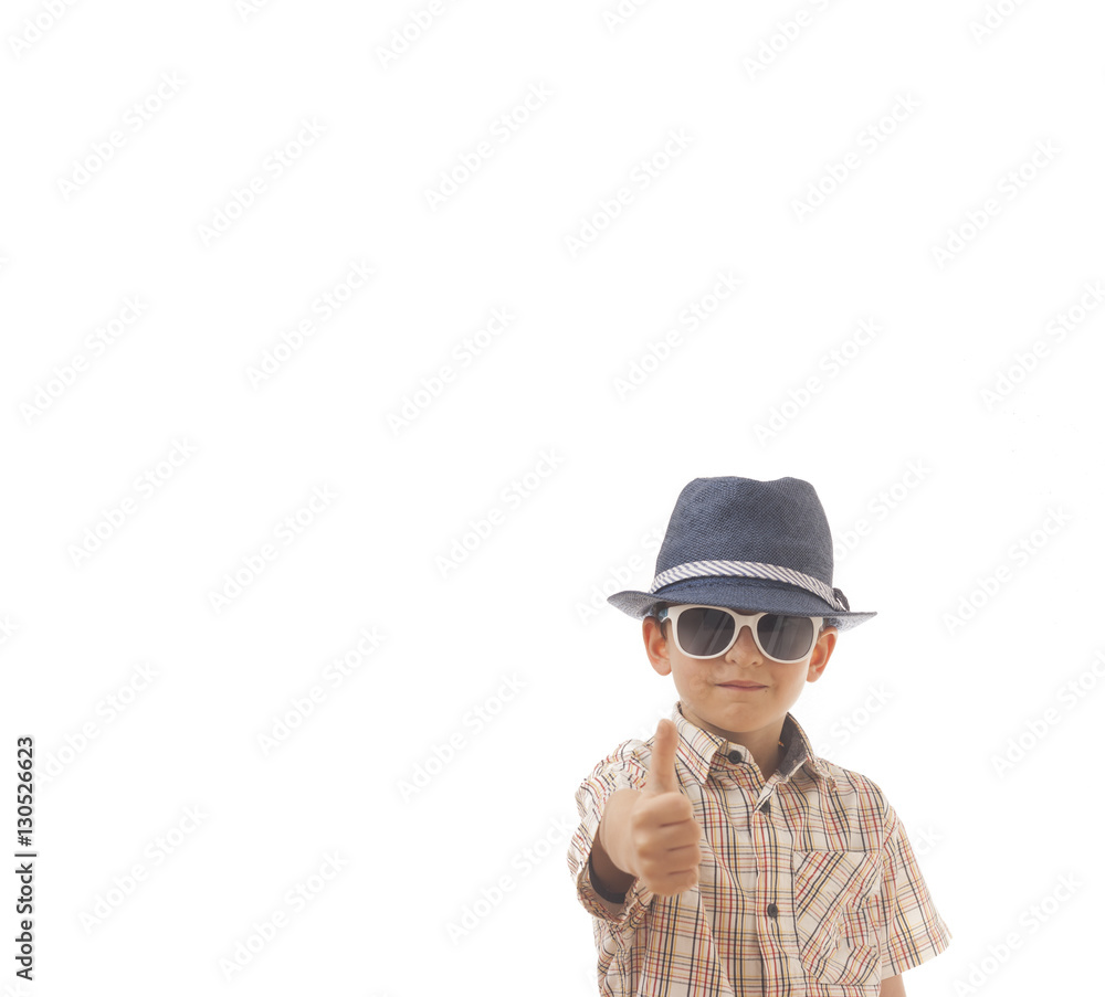 Caucasian kid with hat and sunglasses . Isolated on white background. Space for copy or other design.Thumbs up.Business concept Caucasian kid with hat and sunglasses . Isolated on white background. Space for copy or other design.Thumbs up.Business concept