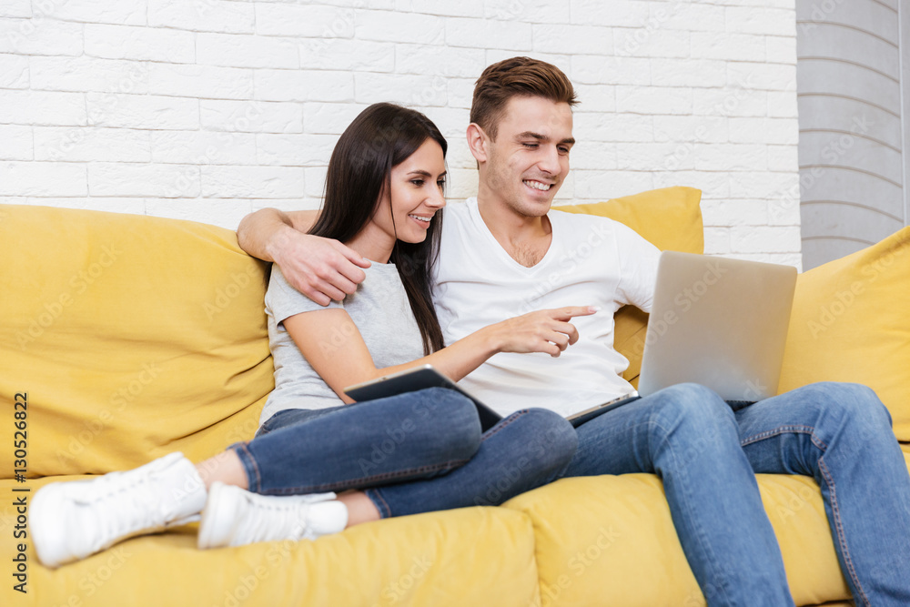 Coworkers sit on sofa in office Coworkers sit on sofa in office