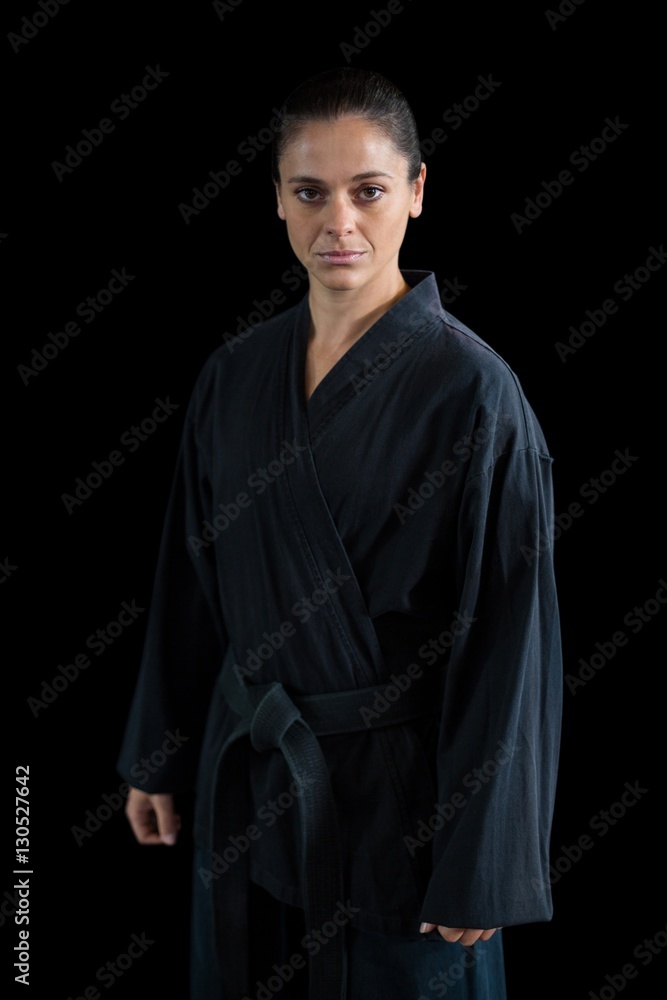 female karate player against black background