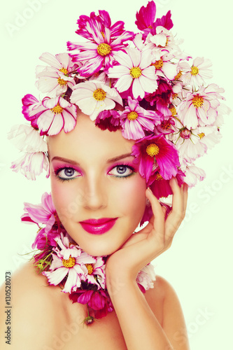 Vintage style portrait of young beautiful sexy girl with stylish make-up and colorful flowers on her head