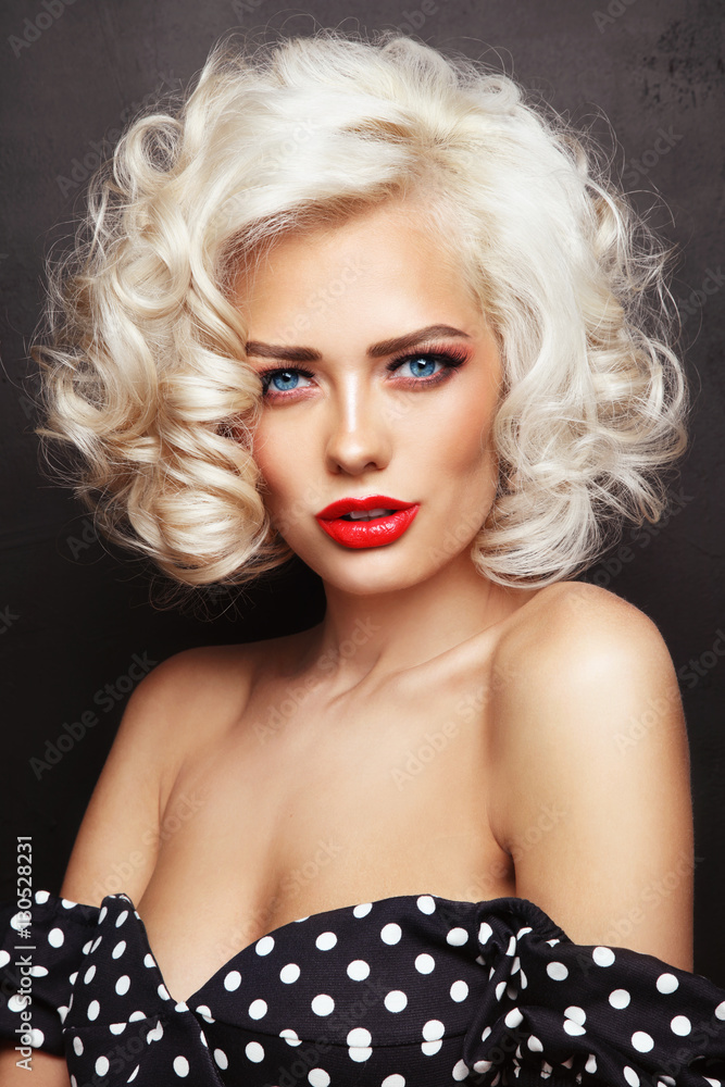 Vintage style portrait of young beautiful sexy blonde pin-up girl with  curly hair and red lips over grunge background Stock Photo | Adobe Stock