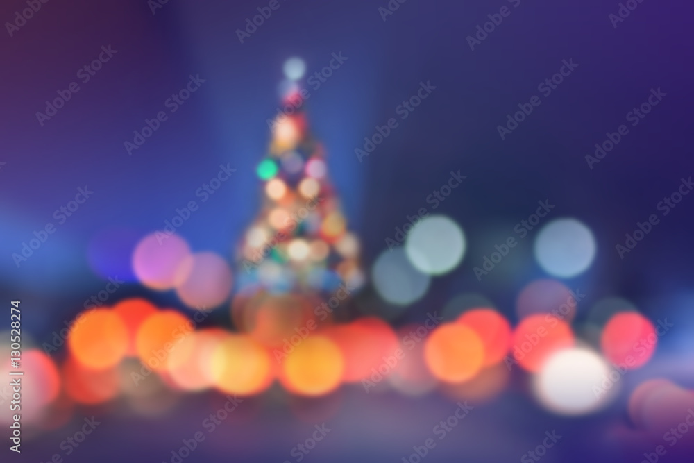 Blurred Christmas Background with Colorful Lighting and Shape of Christmas tree Blurred Christmas Background with Colorful Lighting and Shape of Christmas tree