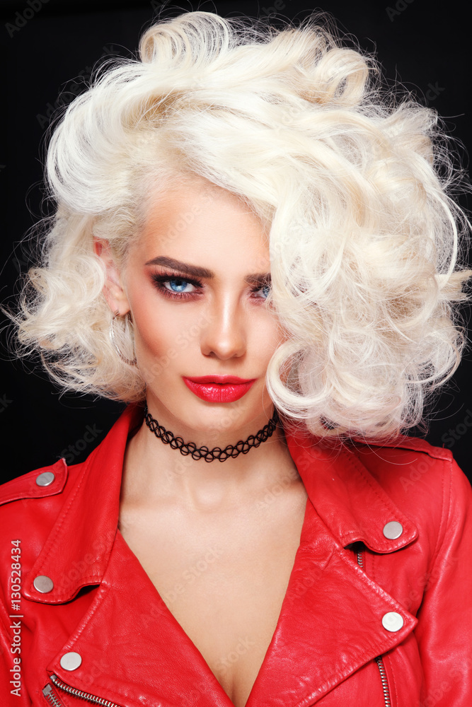 Portrait of young beautiful sexy stylish platinum blonde woman in red leather jacket