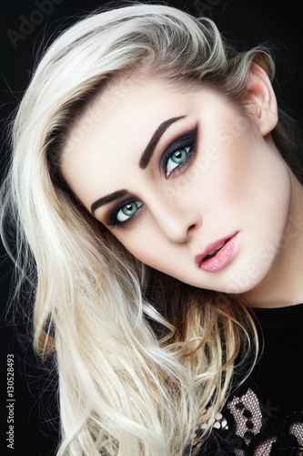 Bild auf Leinwand Portrait of young beautiful woman with long platinum blond hair and stylish wing