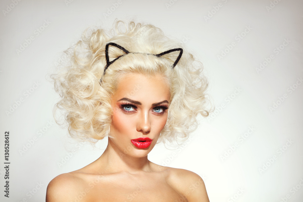 Vintage style portrait of young beautiful platinum blonde sexy woman with fancy hairdo and cat ears headband