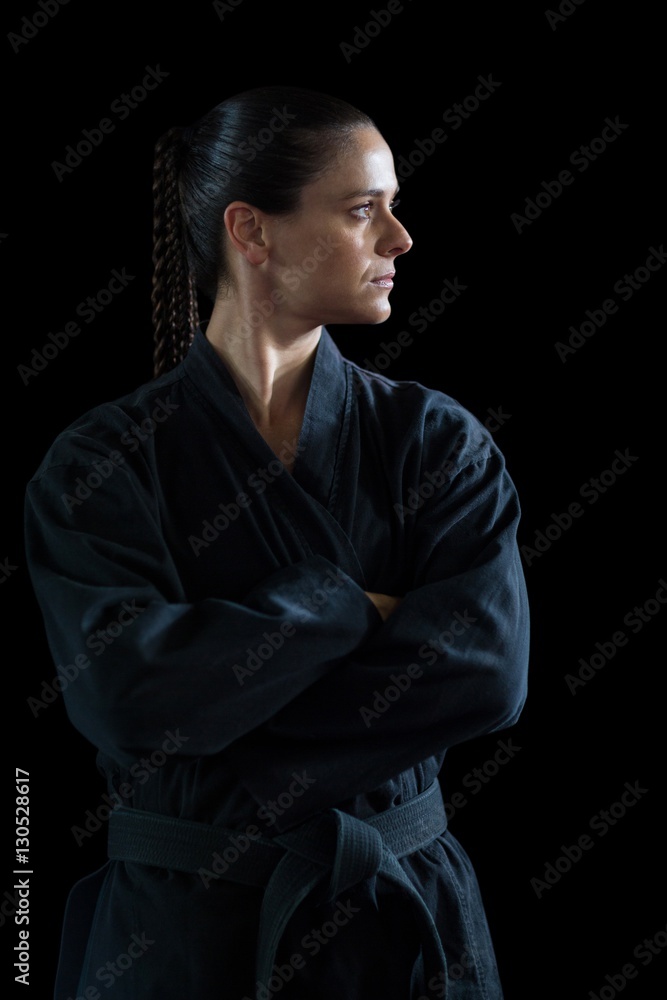 Female karate player standing with arms crossed