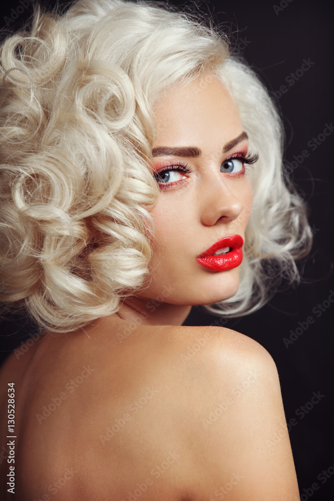 Vintage style portrait of young beautiful sexy blonde pin-up girl with curly  hair and red lips, selective focus Stock Photo | Adobe Stock