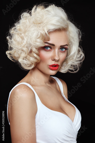 Vintage style portrait of young beautiful glamorous woman with platinum blonde curly hair