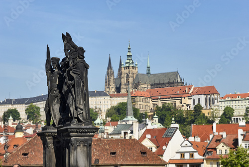 Baroque Statues on the Charles Bridge with beautiful Prague Castle and St. Vitus Cathedral background. Focused to Prague Castle