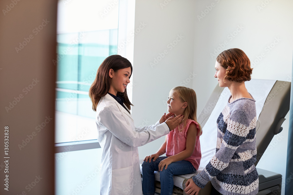 Pediatrician Meeting With Mother And Child In Exam Room Pediatrician Meeting With Mother And Child In Exam Room