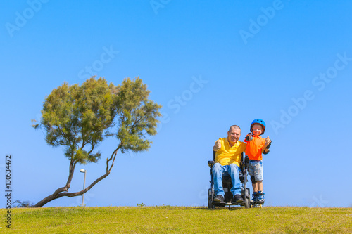 Disabled Father play with his little son © kraevski