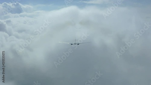 The plane is flying through the clouds