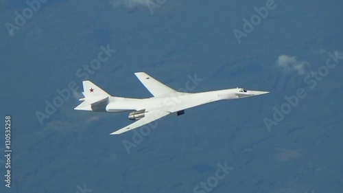 The plane is flying against wood