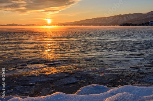 Sunset on frozen lake Baikal