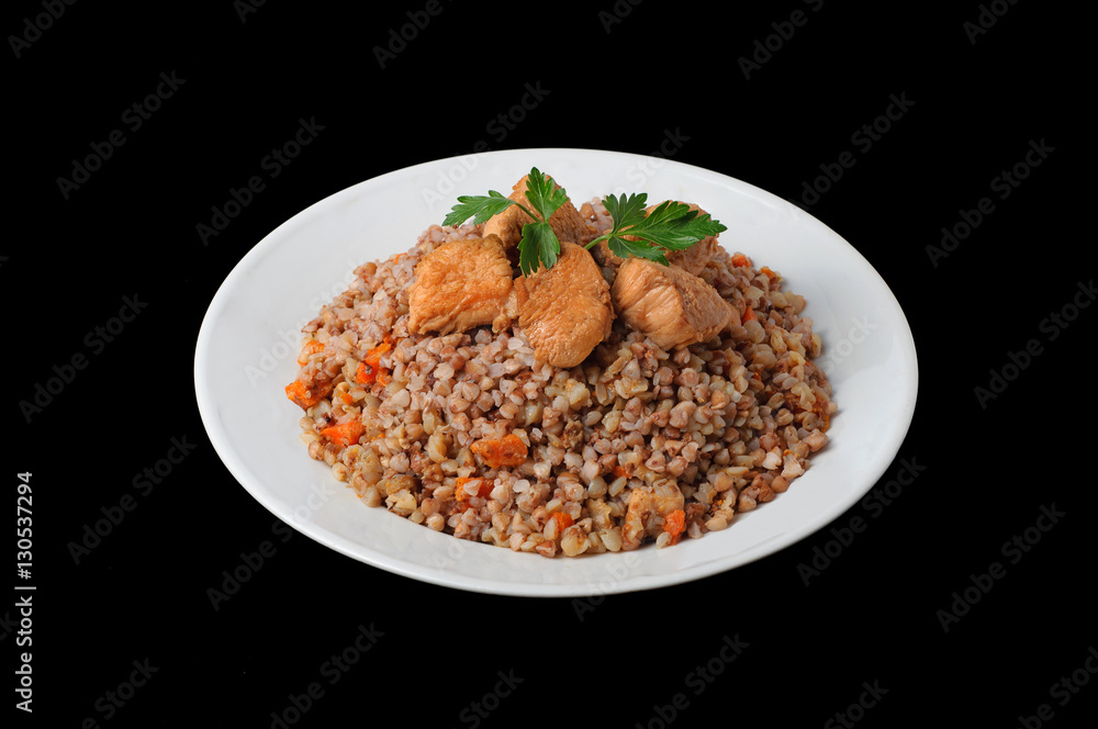 Healthy food. Buckwheat with meat and vegetables on white plate Healthy food. Buckwheat with meat and vegetables on white plate