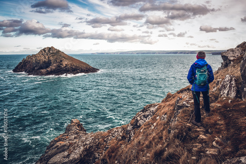 The rumps cornwall england uk, with female walker, hiker rambler. Set in the fantastic landscape waterscape near the ocean photo