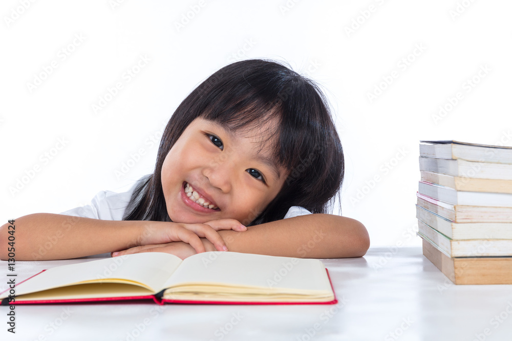 Smiling Asian Chinese little girl reading book Smiling Asian Chinese little girl reading book