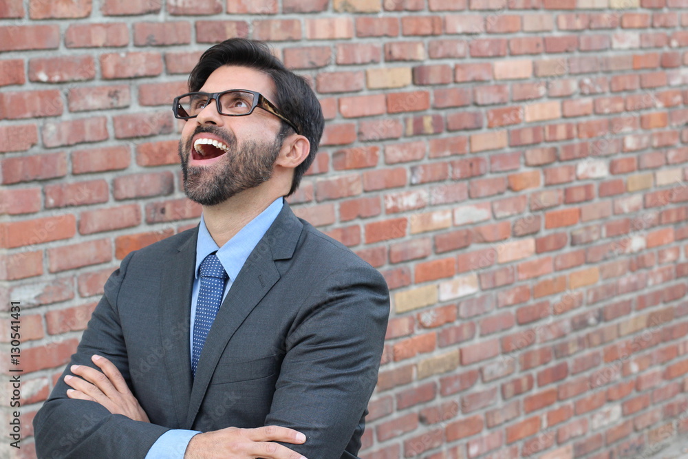 Successful excited business man happy smile looking up to empty copy space, handsome young businessman surprise with arms crossed, isolated over brick wall background Successful excited business man happy smile looking up to empty copy space, handsome young businessman surprise with arms crossed, isolated over brick wall background