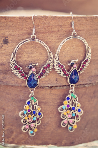 Peacock earrings with colorful beads photo