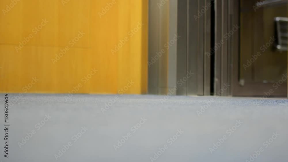 Young man get off from elevator - close-up legs Young man get off from elevator - close-up legs